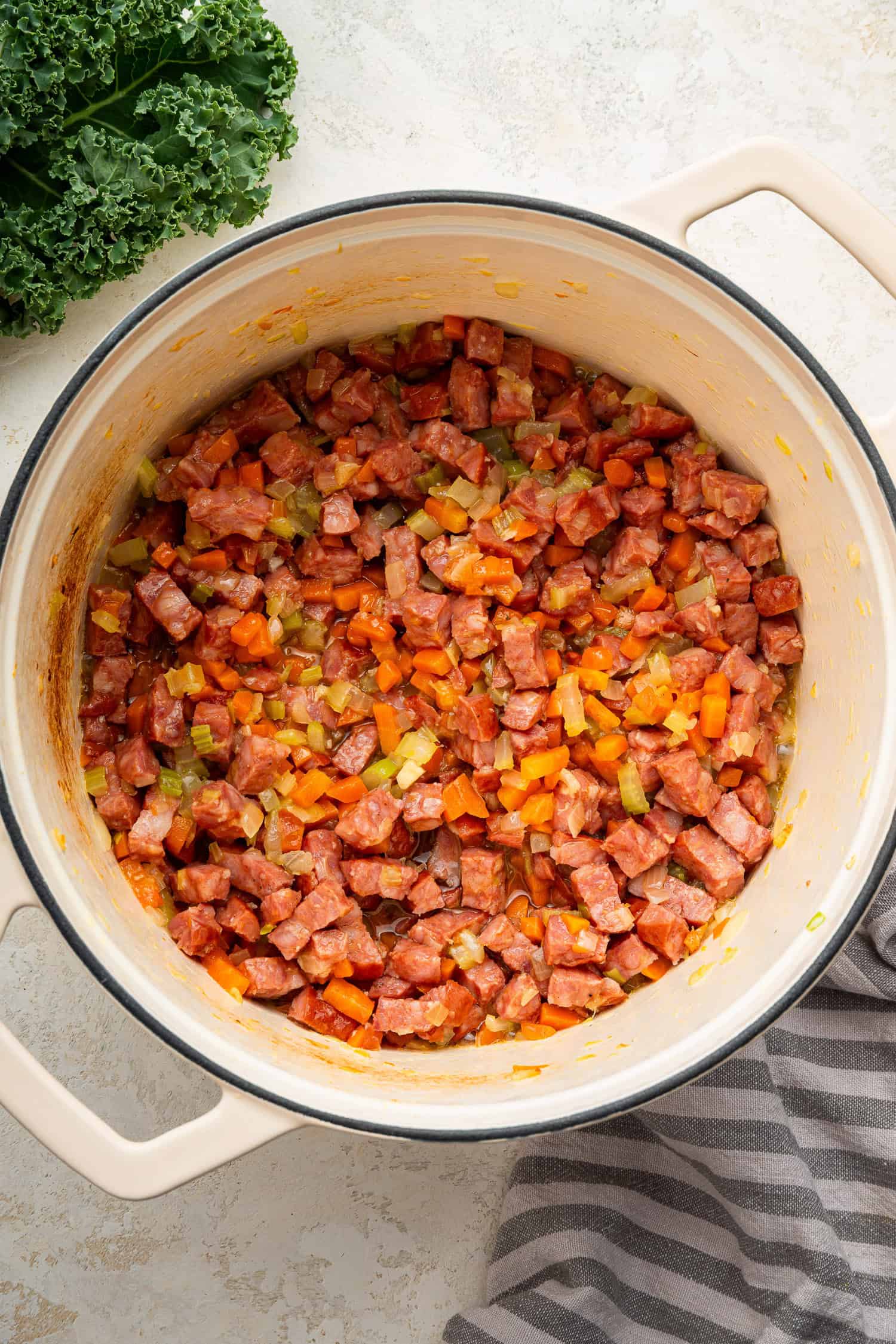 Vegetables and meat diced and placed in pot for soup. 