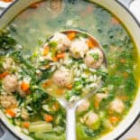 Pot of Italian Wedding Soup with large spoonful on top.