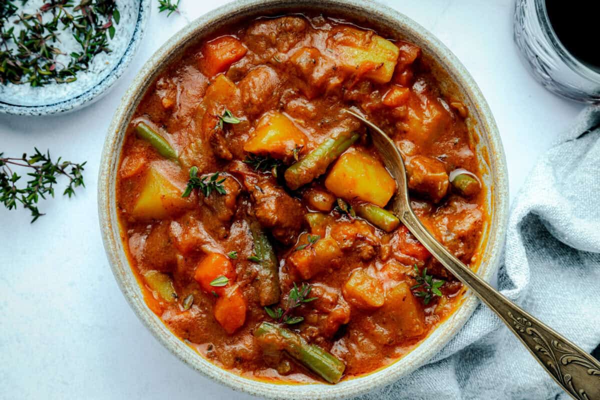 Big bowl of beef stew with spoon. 