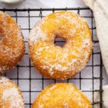 Potato donuts on wire rack.