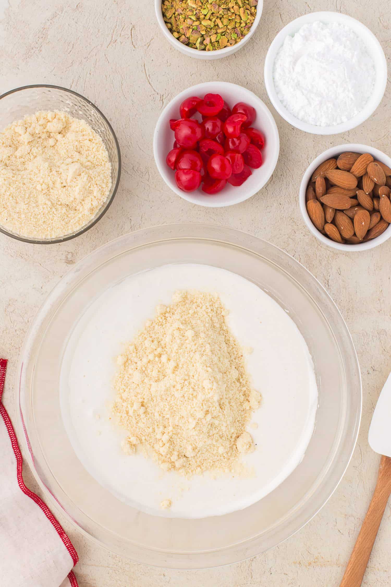 Adding flour to egg white mixture. 