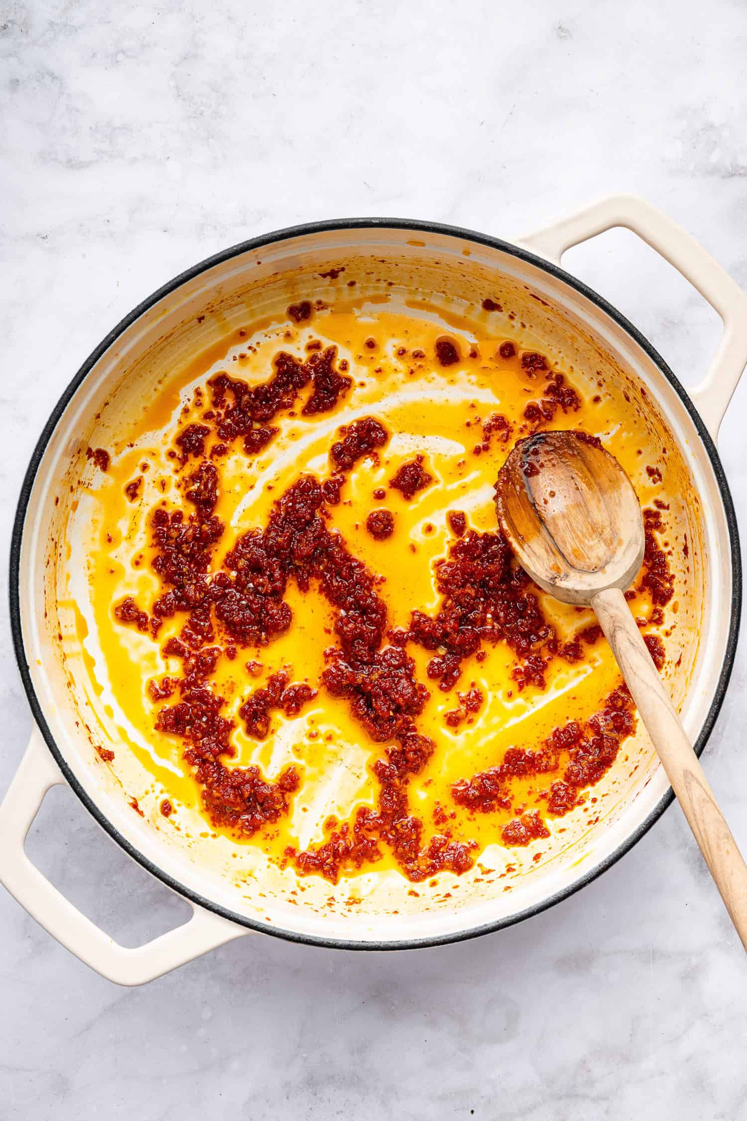 Garlic and red pepper flakes in olive oil in pot. 