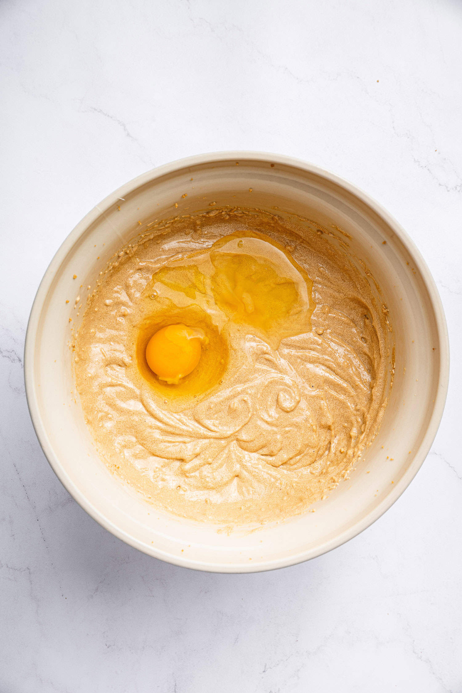 Adding eggs to cake batter. 