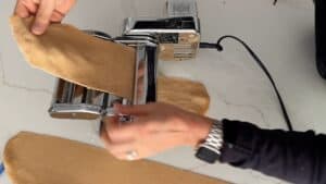 Rolling dough with pasta machine.