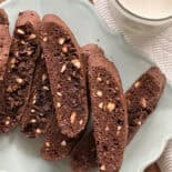 Chewy chocolate biscotti with chopped nuts served on a decorative plate.