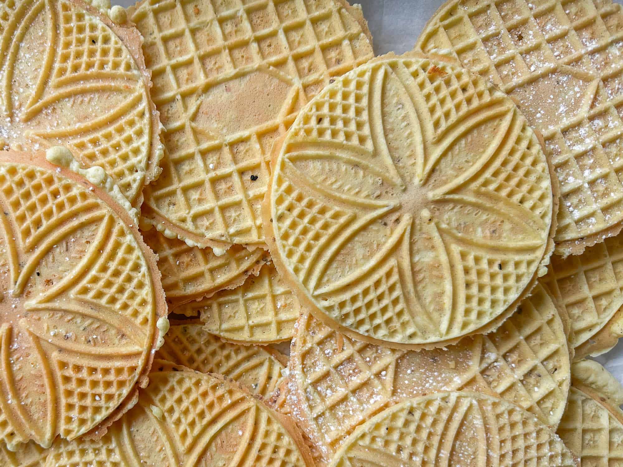 Delicious patterned pizzelle cookies, perfectly crisp and sweet, ideal for snacks or desserts.