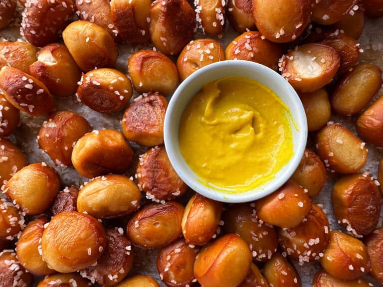 Top view of pretzel bites with small bowl of mustard.