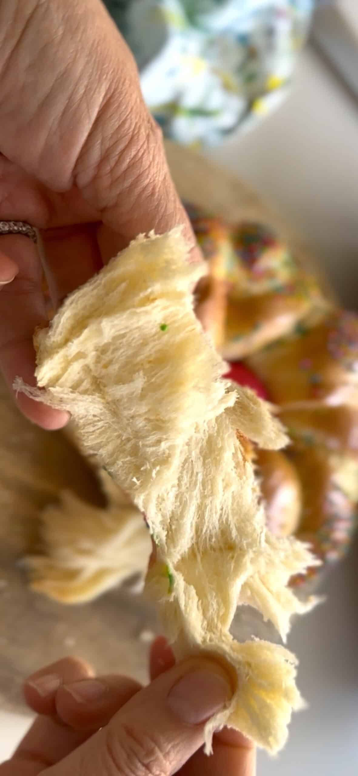 Torn piece of Italian Easter Bread showing soft crumb. 