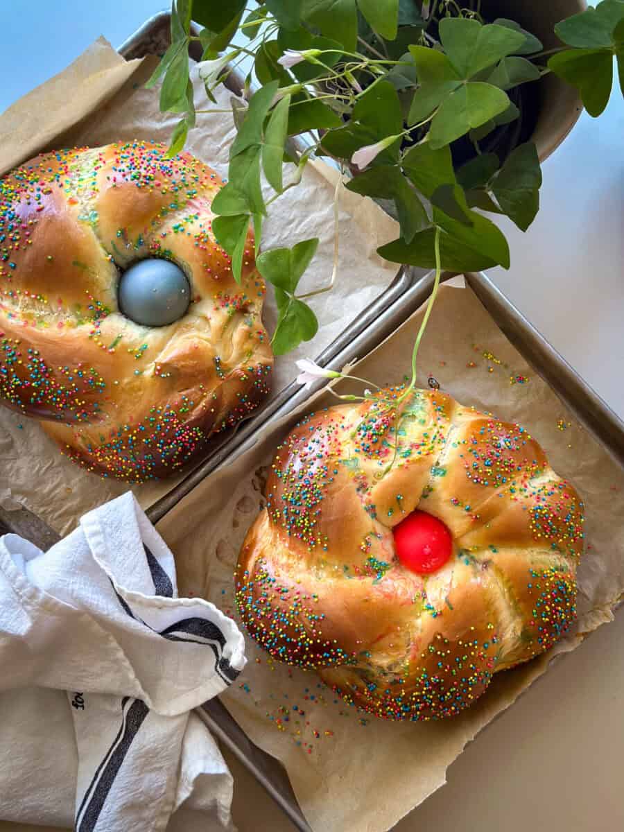 Two loaves of Italian bread with blue and pink eggs. 