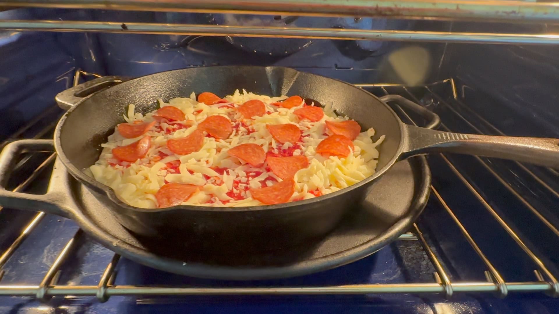 Placing pizza in the oven. 