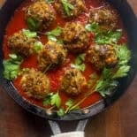 Pan with Eggplant meatballs in tomato sauce with parsley.