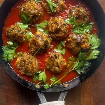Pan with Eggplant meatballs in tomato sauce with parsley.