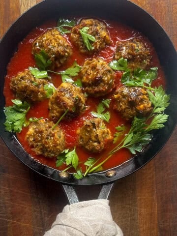 Pan with Eggplant meatballs in tomato sauce with parsley.