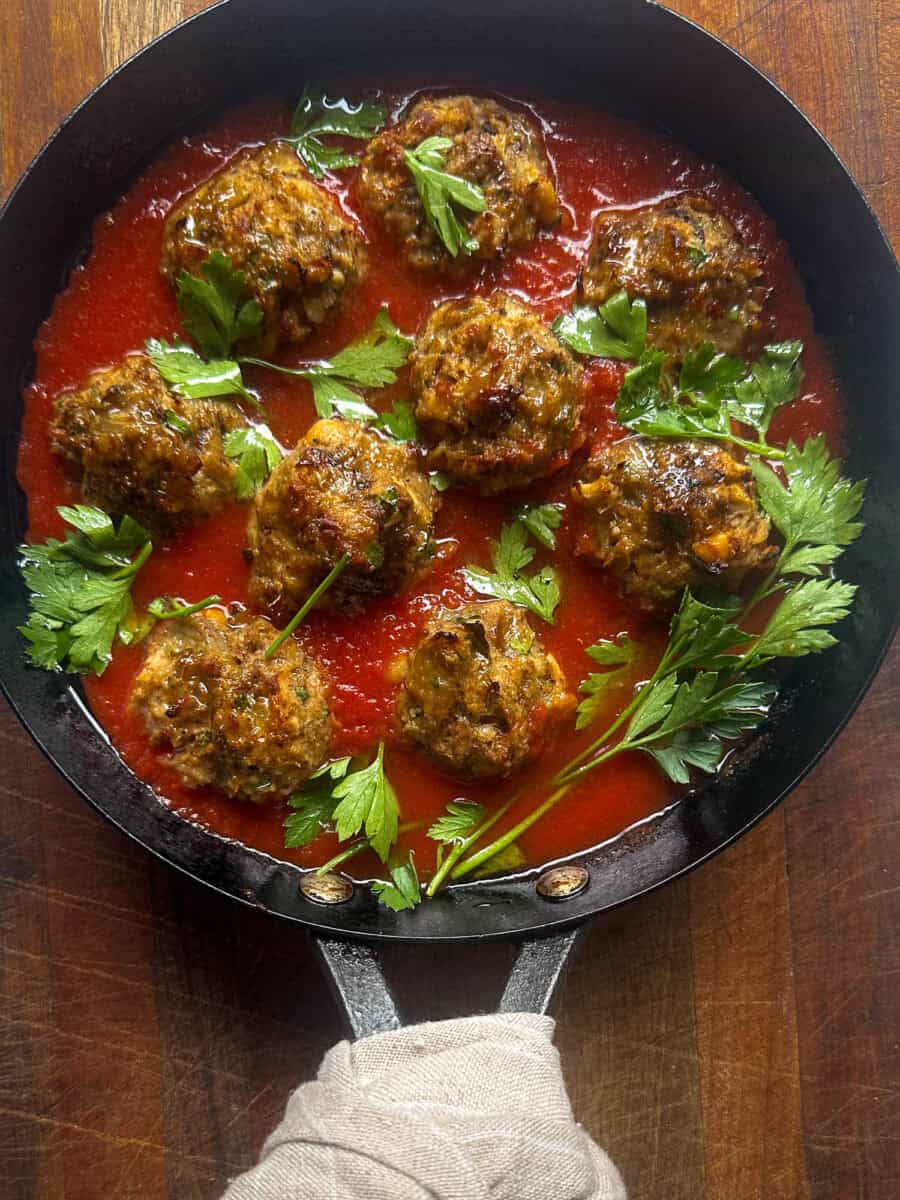 Pan with Eggplant meatballs in tomato sauce with parsley.