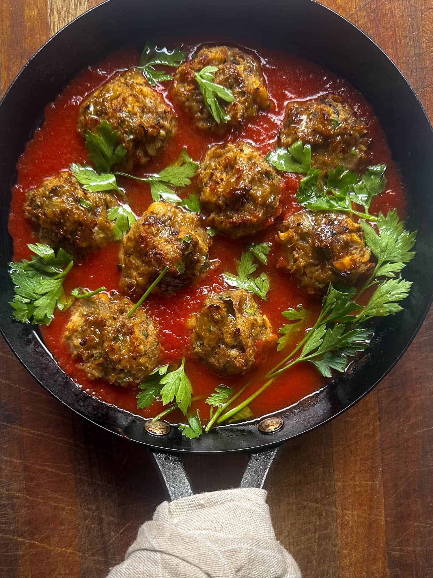Pan with Eggplant meatballs in tomato sauce with parsley. 