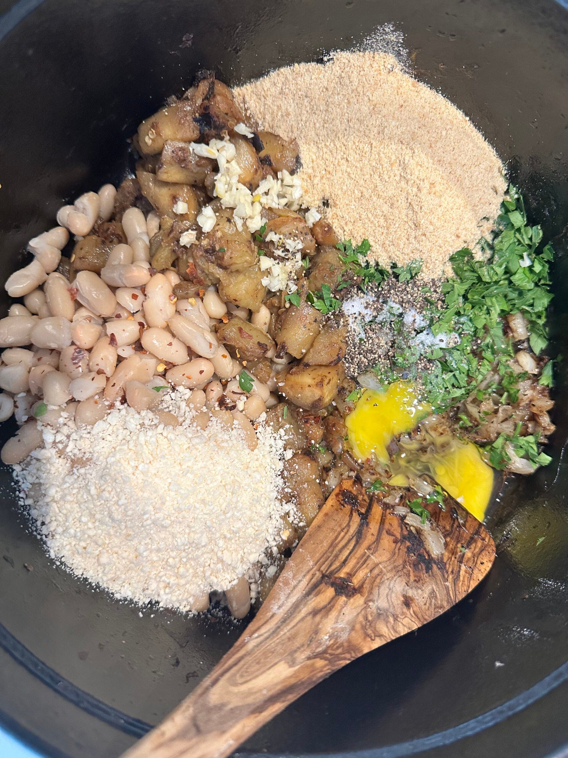 All ingredients for eggplant meatballs in big pot. 