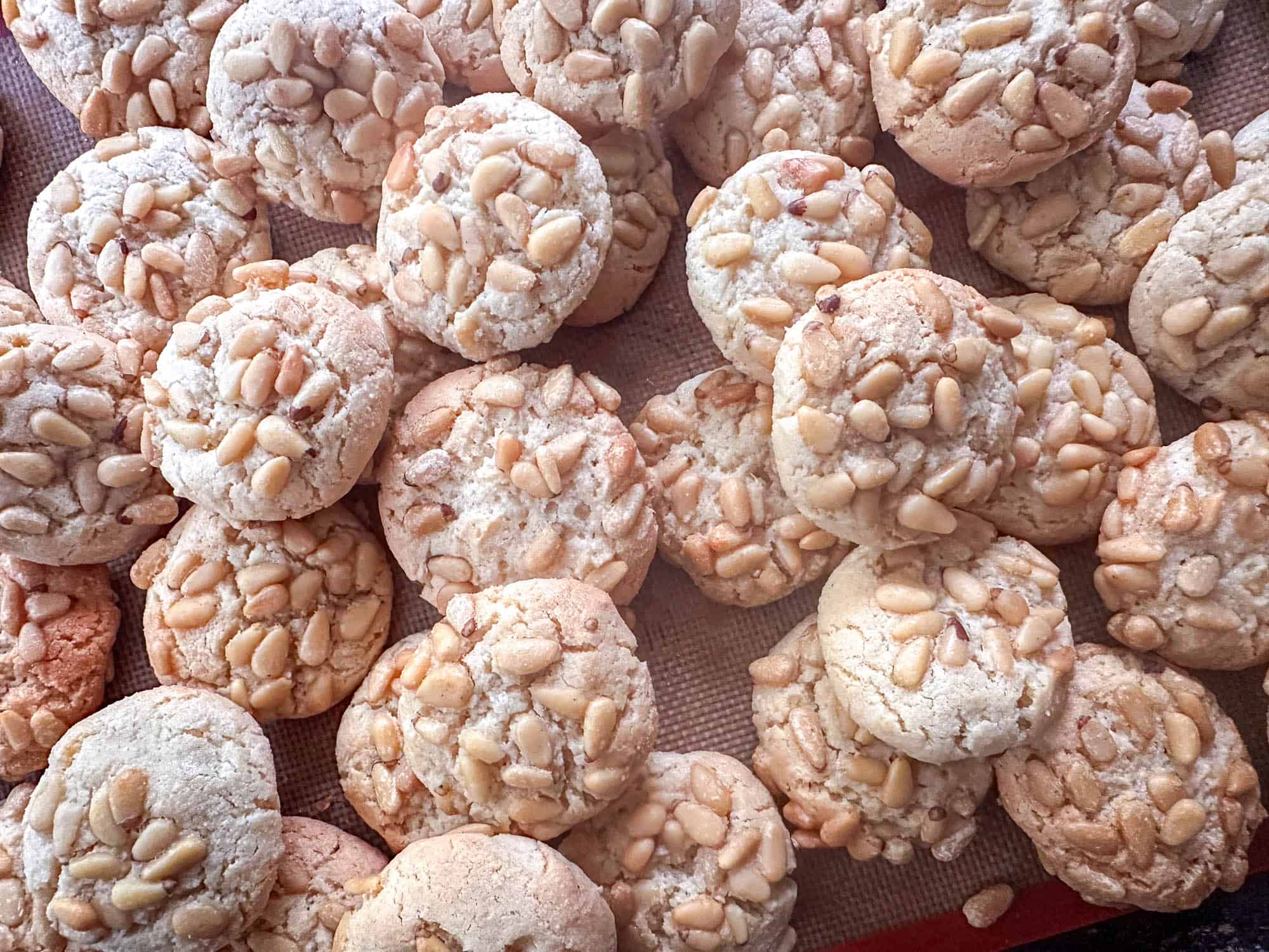 Pignoli cookies on baking sheet. 