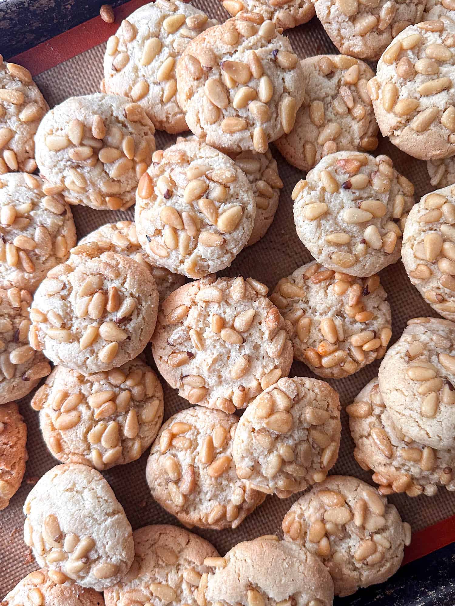 Pignoli cookies on baking sheet. 